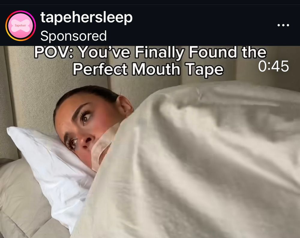 A woman lies in bed with tape over her mouth. The caption says “POV you’ve found the perfect mouth tape”