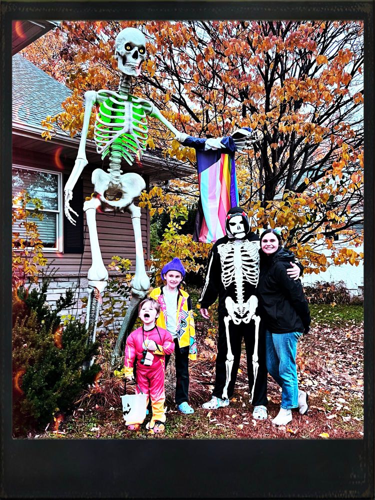 Our family of four, dressed up, and hanging out with a 12 foot tall skeleton. 