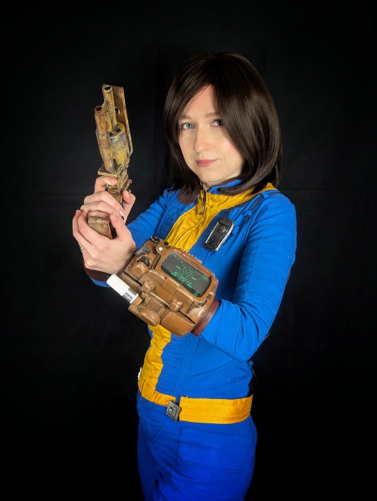 Me wearing my self-made Fallout cosplay: The classic blue Vault suit. I'm holding a selfmade pipe revolver and you can see the pipboy I made