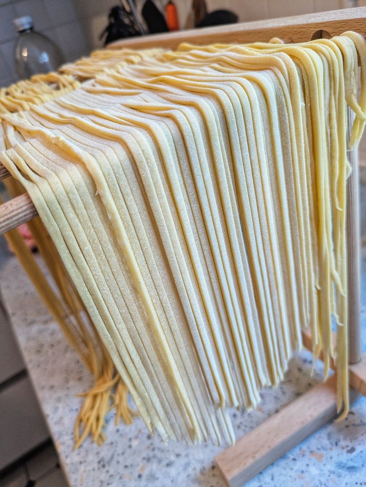 Selfmade Pasta (Linguine) hanging on a noodle rack