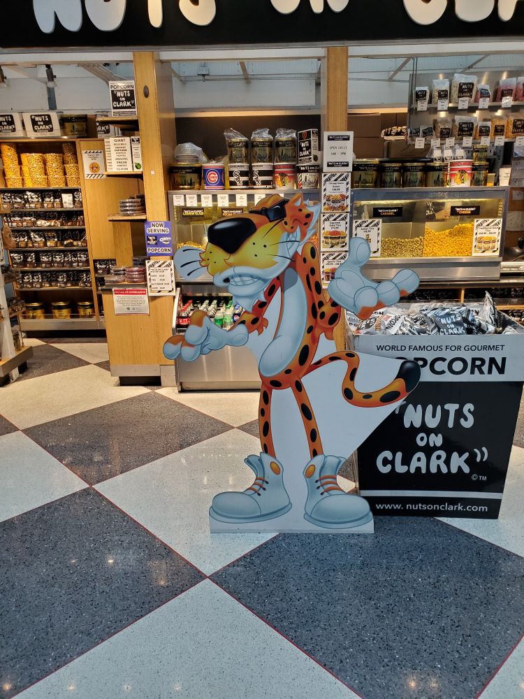 Chester Cheetah standee in front of a Nuts On Clark shop.