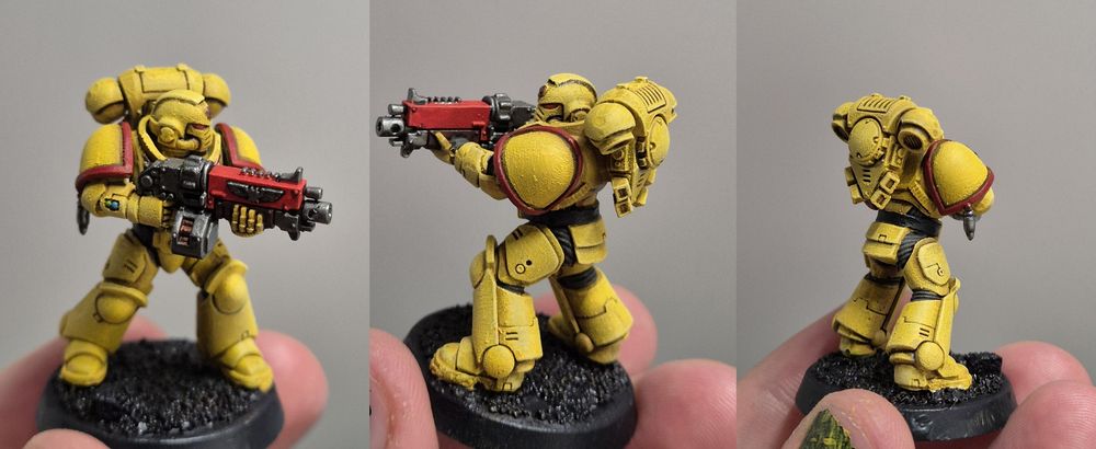 More bulwark than marine, a walking fortress, a true son of Dorn. It's a Space Marine Intercessor figurine, very basic posture aiming over the barrel of it's bolt gun. It's a bright yellow, the colours of the Imperial Fists, with red trimmed pauldrons.