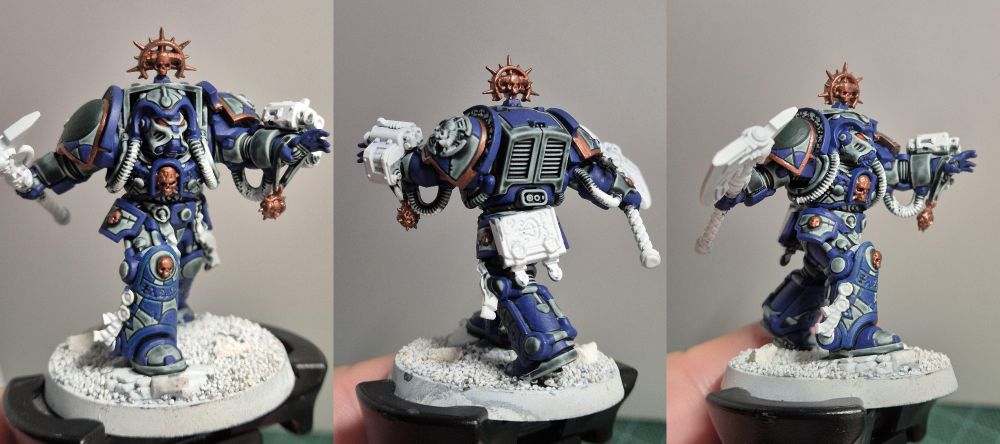 Three side by side images of the Leviathan box librarian. His armor, divided in segments, is partially blue, partially grey painted. He is shown from different POVs, the front, from behind, the side.
Most of his details are not yet painted and he is lacking highlights and shadows. But his eyes are already red.