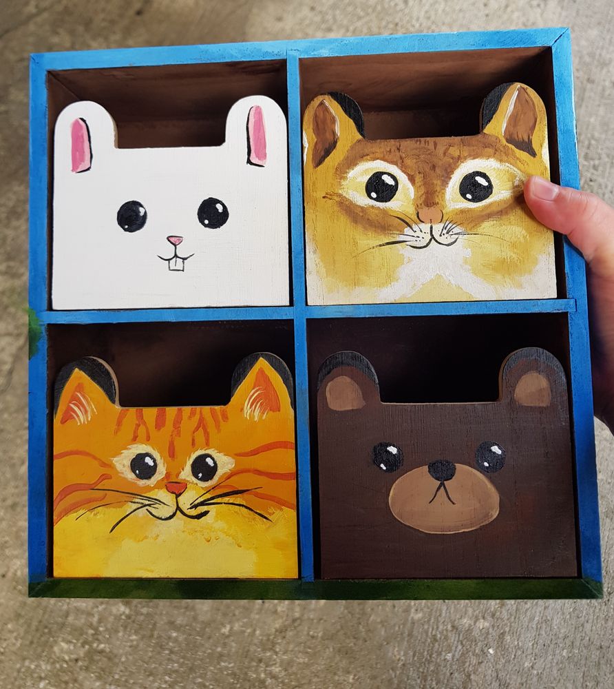Painted animal cubbies made to look like a rabbit, a chipmunk, a cat, and a bear.
