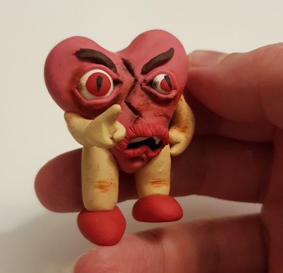 A broken heart with arms and legs and a disturbing face.