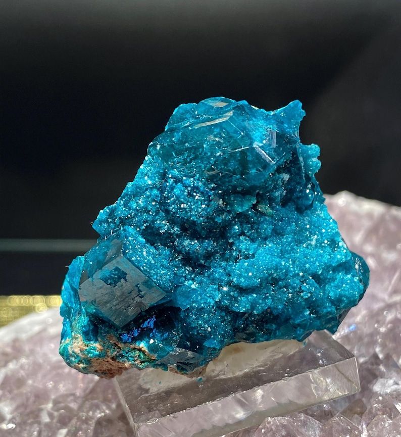 Dioptase that is BLUE.

A druzy dioptase crystal specimen from Namibia. There is a cube forming at the bottom left, but it's a translucent ghostly version of a Borg cube assimilating into the galaxy of dioptase above and in part around it.