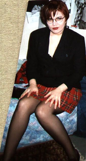 At a friend's place before heading out. Short or more cropped dark red hair and red tartan mini. Maybe a bit of an "I know what you want"-ish expression.
What is this looking villainous thing you speak of?
And how I used to look relatively 'skinny' back in the day and not have realistic ideas of that.
