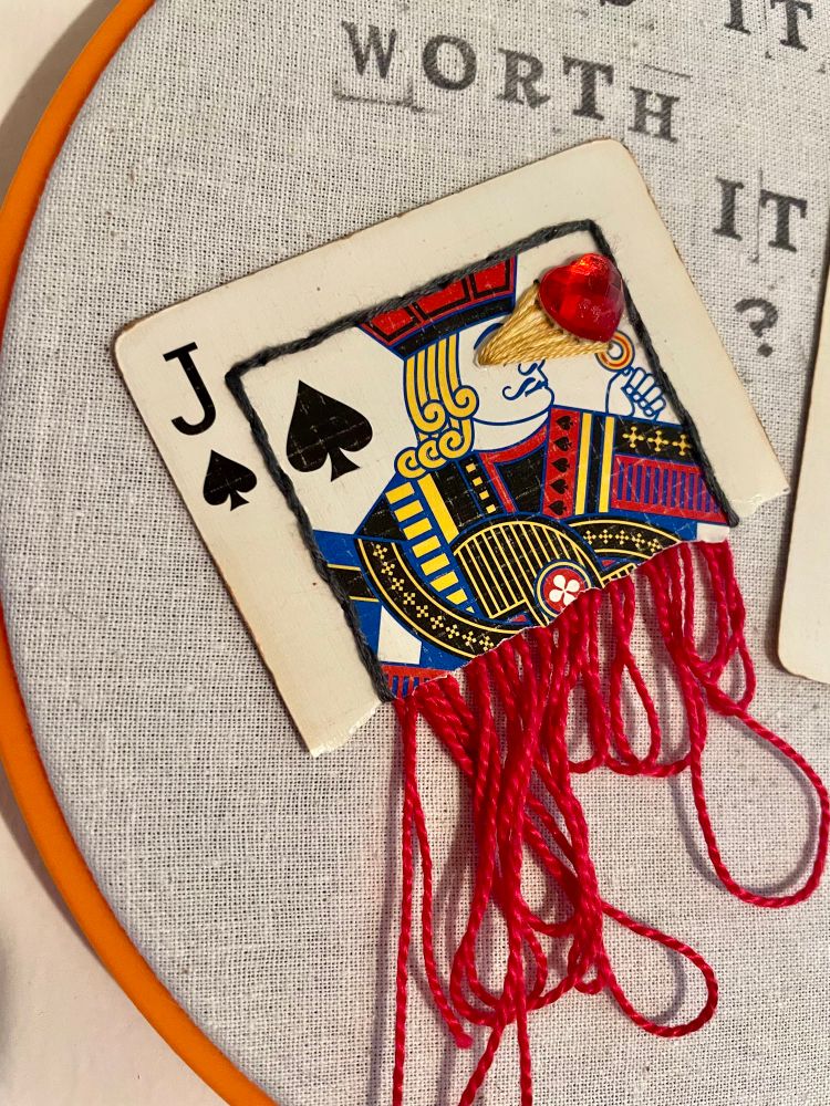 Mixed media embroidery hoop art made with playing cards. 