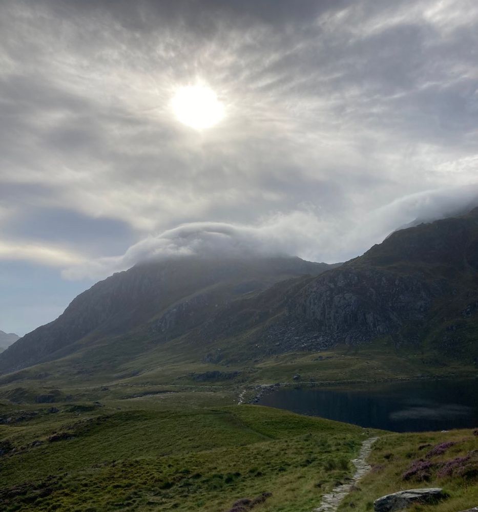 A mountain with clouds on its summit 