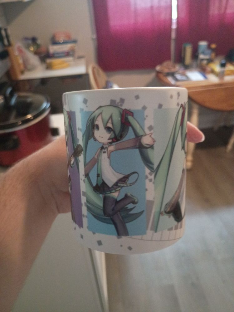 A mug with several pictures of Hatsune Miku on it