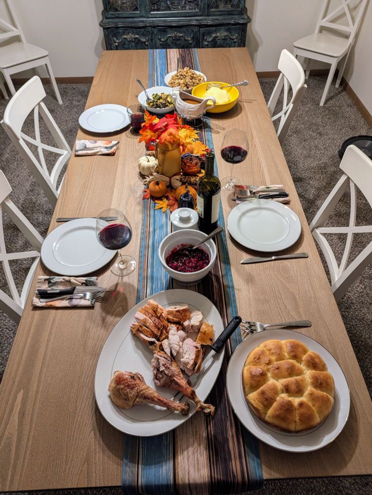 Table set with various thanksgiving dishes.