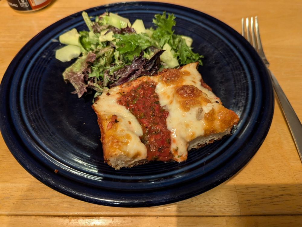 Corner slice  with a green salad.
