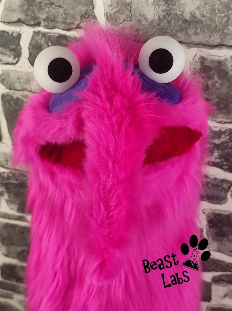 Front view head shot of the hot-pink akward worm puppet.