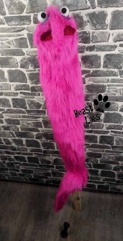 Full lengh view of the akward worm puppet, including the tail rod