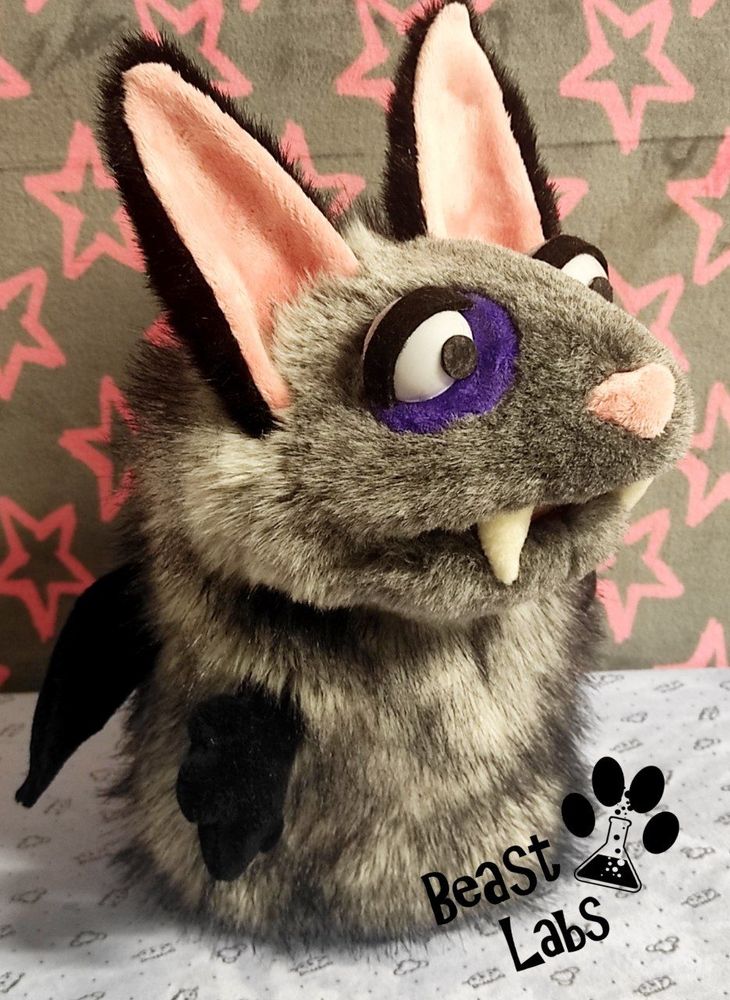 Picture of a grey and black bat-cat hand-puppet. This is the right side view.