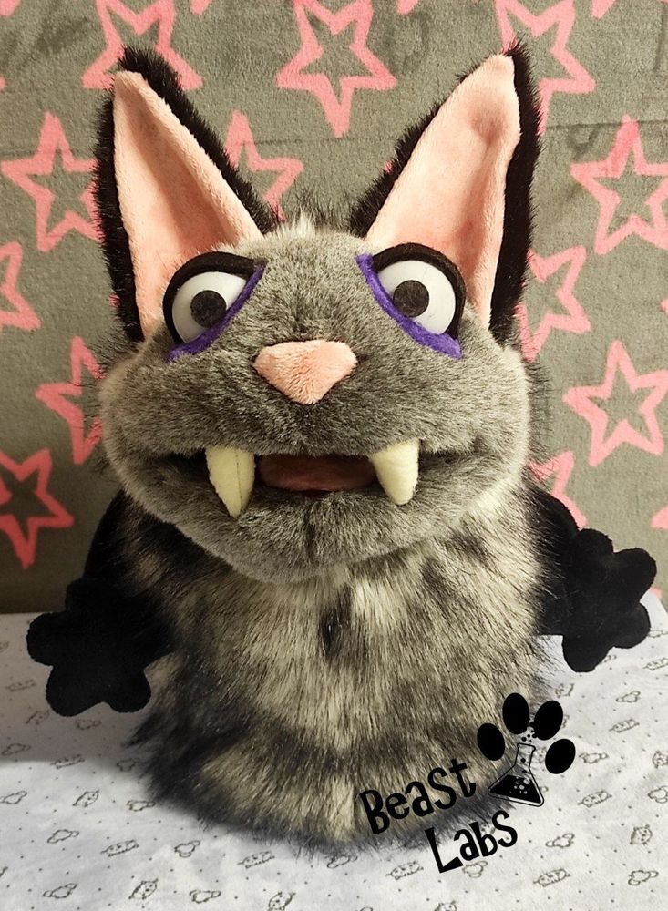 Picture of a grey and black bat-cat hand-puppet. This is the front view.