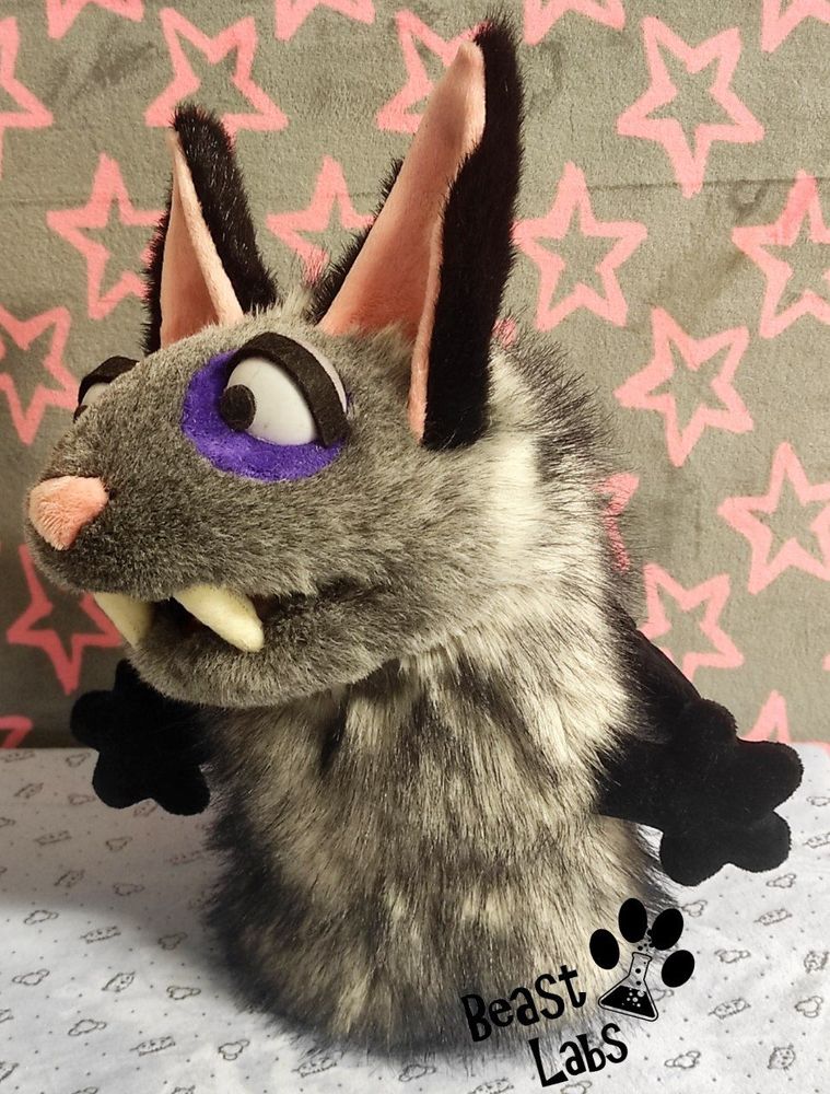 Picture of a grey and black bat-cat hand-puppet. This is the left side view.