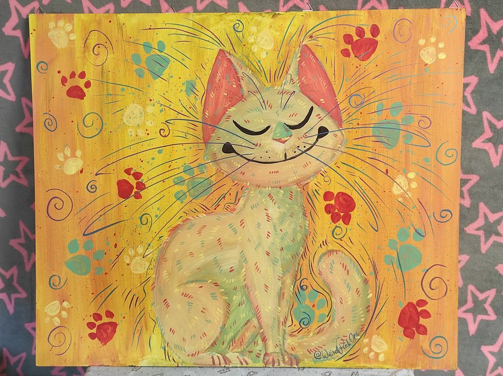 Acryllic painting of a cream, blue, green and pink kitty with wide eyes, a big, sharp toothed smile and a slightly hunched back on a dark background, that is sprinkled and lined in different coloures.