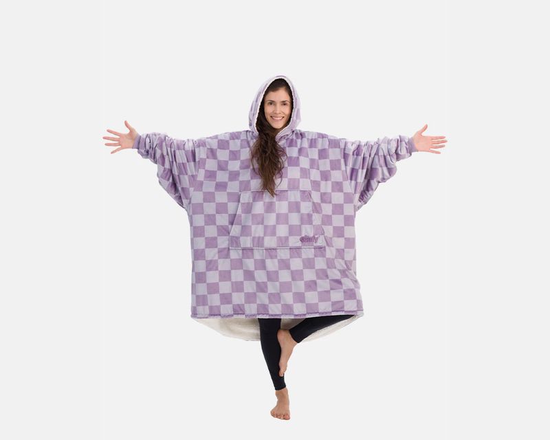 lady wearing a large blanket hoodie with her arms out standing on one leg like she’s in a yoga pose god i wish i was her