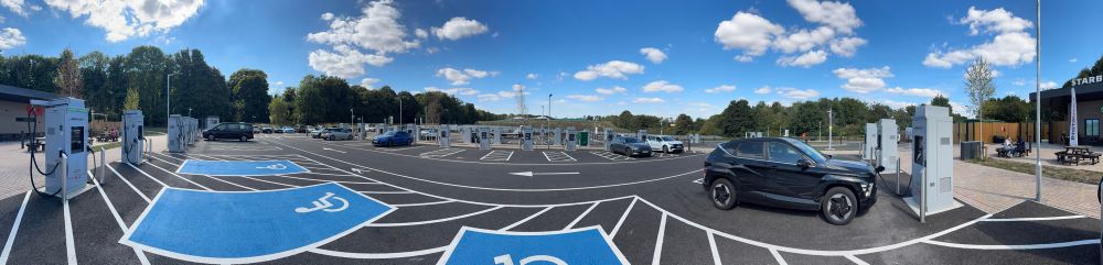 A panorama of an Instavolt charging forecourt.