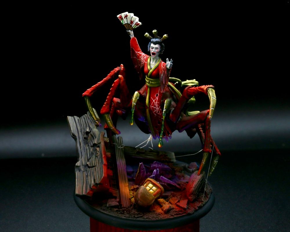 Spider woman coming out of rubble to defend a dark stone deposit, a lantern lights her from below.