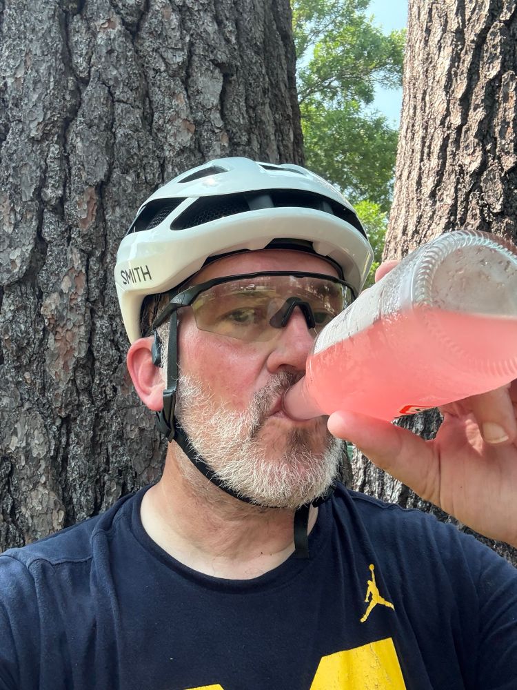 Me sitting under a tree drinking a guava flavored Jarisco after my ride. 