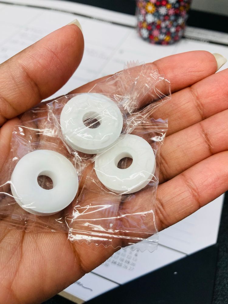 My left hand with three Life Savers mint candies, individually wrapped, in the palm. Aug 5, 2025.