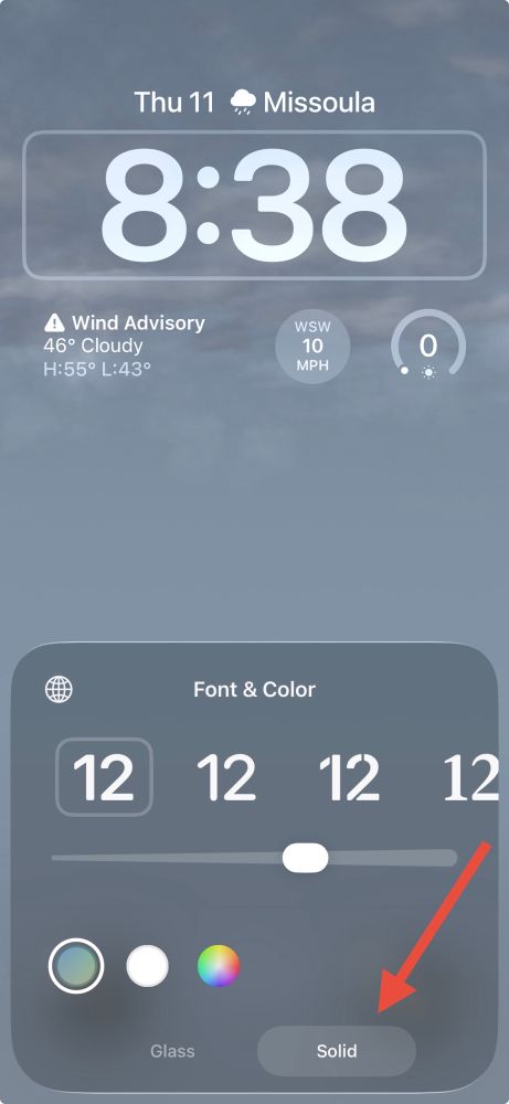 A screenshot of the iPhone lock screen clock settings with a red arrow pointing to an option in the bottom right labeled “Solid”.