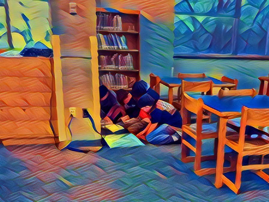 4 boys on the floor huddled over atlases