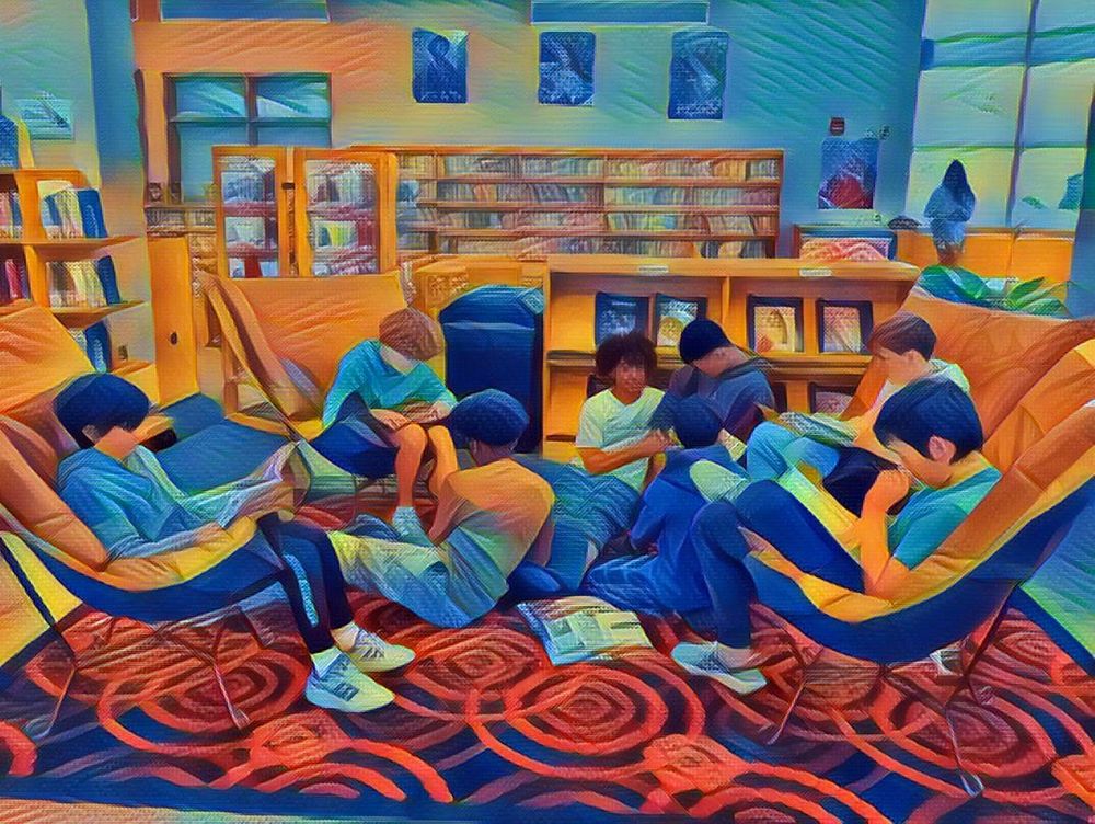 9 boys seated together in comfy chairs and on the floor reading books