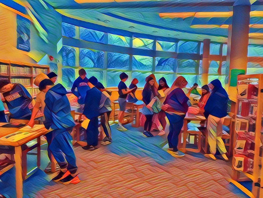 students discussing projects with each other in the library