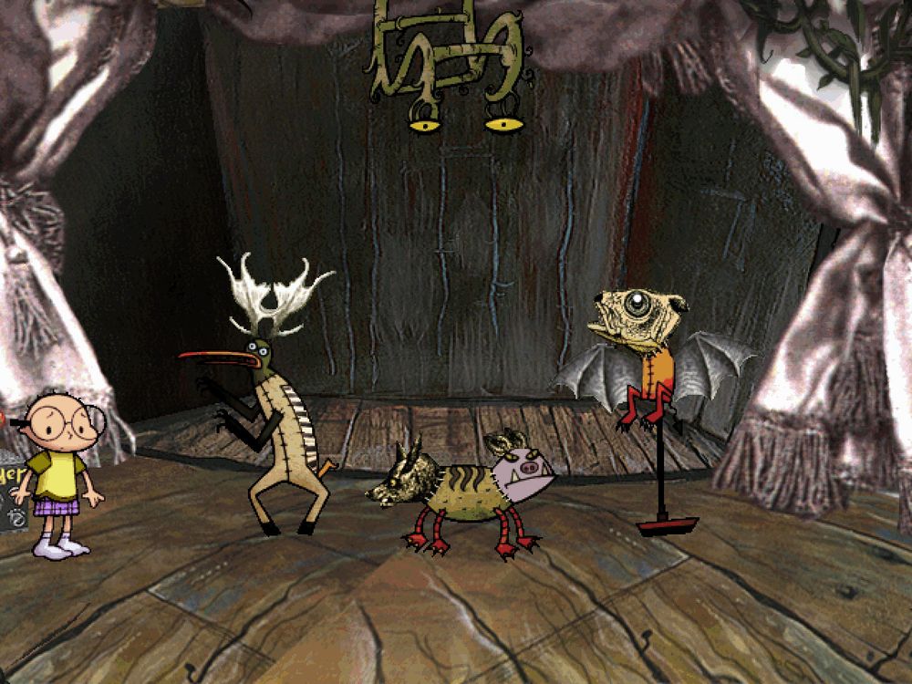 A screen from Nightmare Ned that looks like a stage with curtains. Ned is on the left. 3 creatures assembled from taxidermy with each piece in a different art style are in the center of the screen. On has a bird head with moose antlers on a deer-like body sewn together with obvious patches from other creatures. In the middle, a creature has a heavily detailed dog head on one end of the body and a cartoony gargoyle on the other end. The creature's body is a tube and it has four duck legs. The final creature has a semi-realistic drawing of a fish head with large eyes and bat wings on a yellow body with red legs. It is on a tall perch. A vine-like ladder is at the top of the screen and it has eyes on the end.