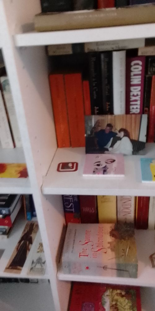 White bookshelf full of books, and an old photo I found in my Aunty's effects of my Da and me ?watching telly. I was about 17 here. My Da was younger here than I am now. Forever thankful I grew up in a home always full of books, and his lifelong love of history. Wonderful legacy.🙏