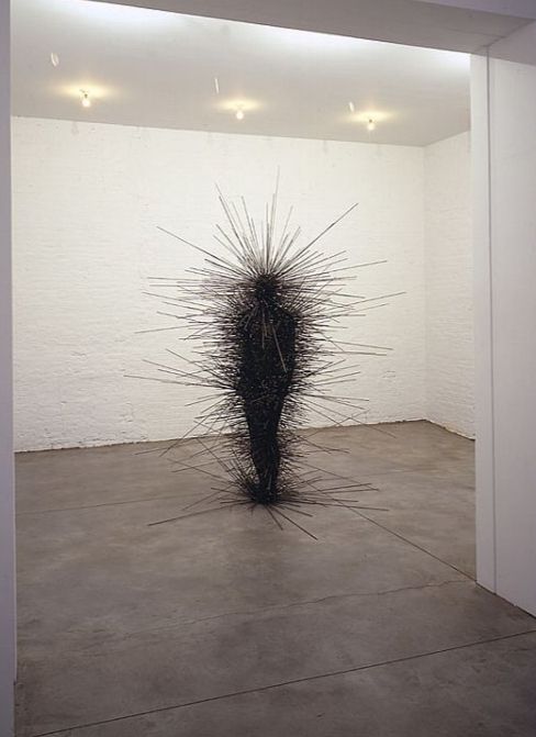 Series of thin metal rods that suggest the presence of a human figure
