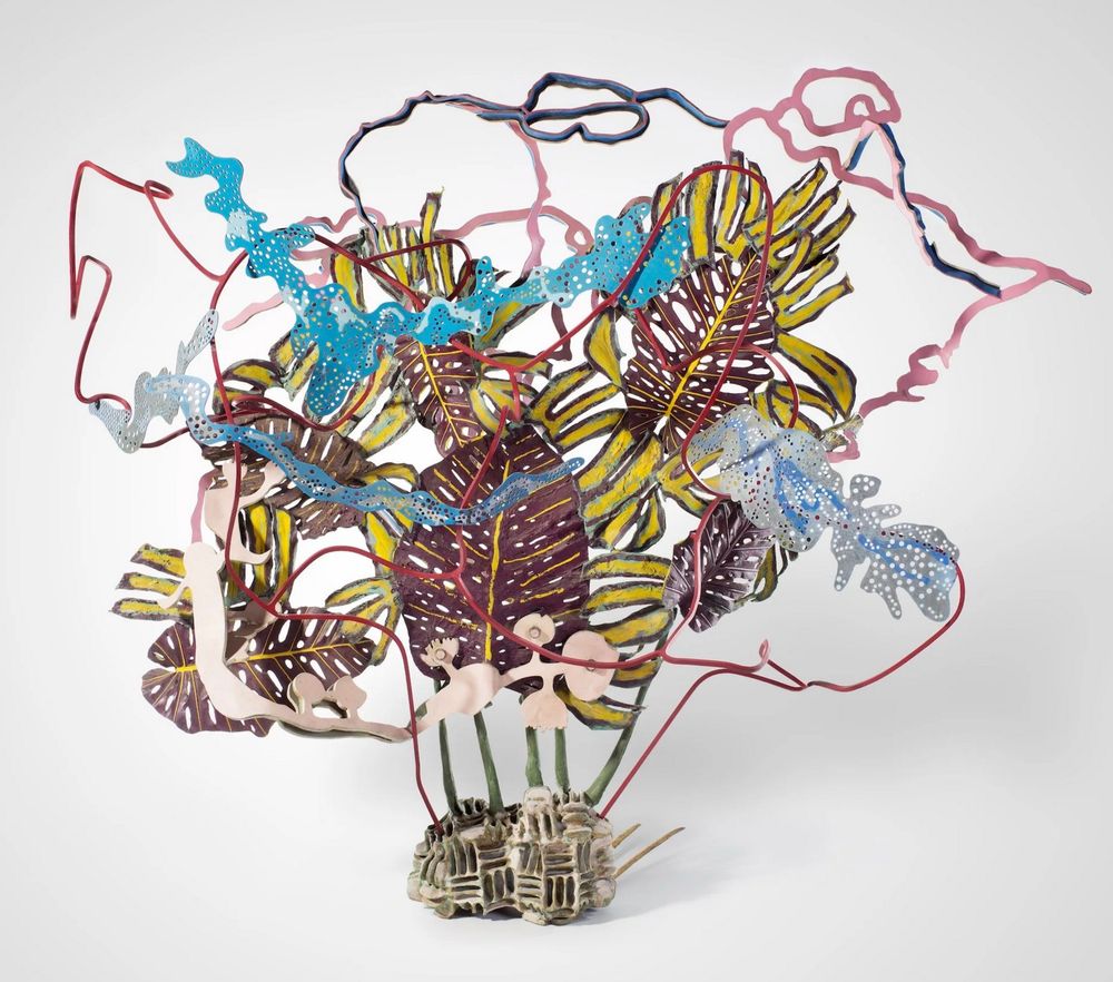 Complex, multi-colored sculptural form made up of different elements - some linear, some leaf-like - assembled together