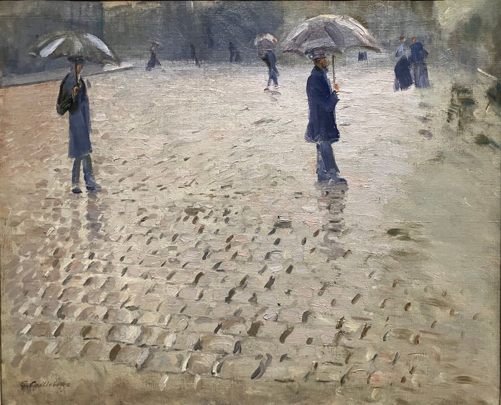 Painting of a rainy cobblestone street with a few walking figures under umbrellas