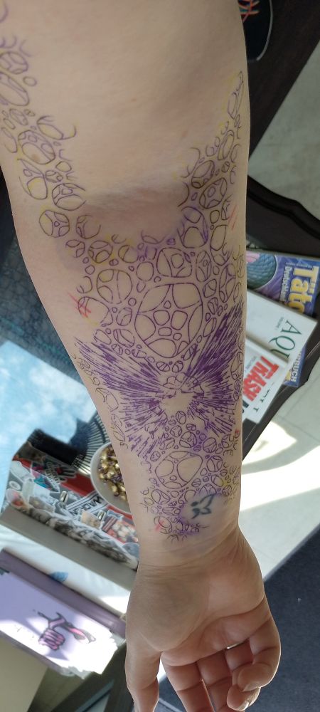 A Photo of a tattoo stencil on a lower arm.