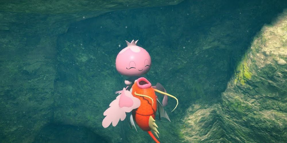 An ecstatic jellyfish pokémon, Frillish, dragging a defenceless Magikarp to its doom in the depths.