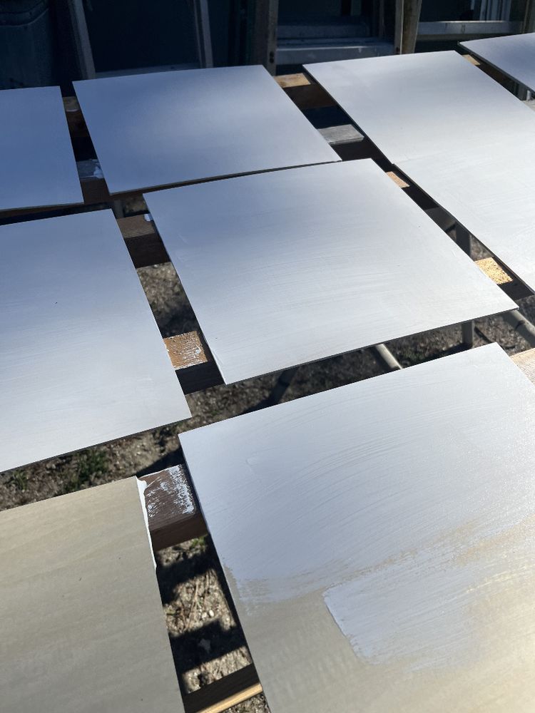 Panels laid out and being painted.