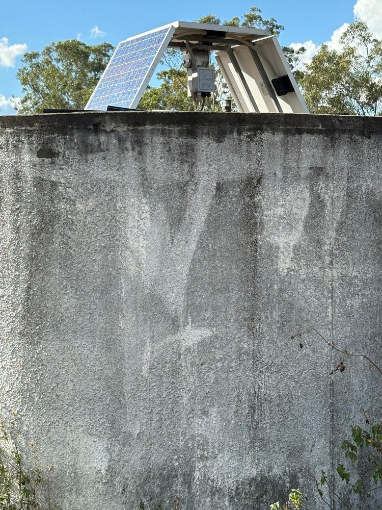 A water tank with a solar panel on top.