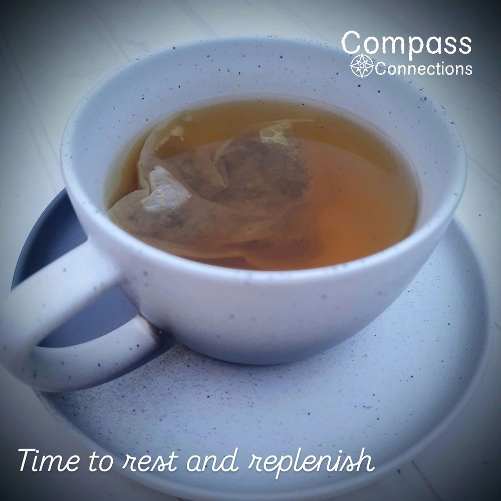 Pottery cup and saucer with teabag resting in hot water