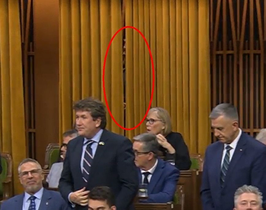 Scheer and Reid hiding behind a curtain in the House of Commons during the Budget Vote Nov. 15 2025.