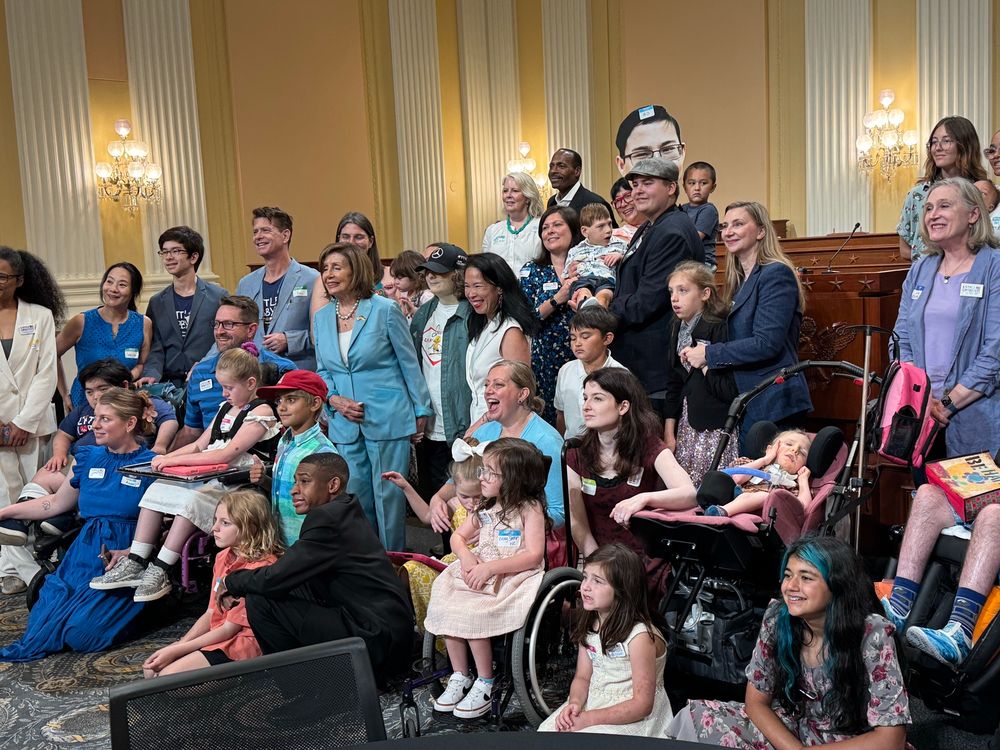 A group of medically complex children pose with House Speaker Emerita Nancy Pelosi