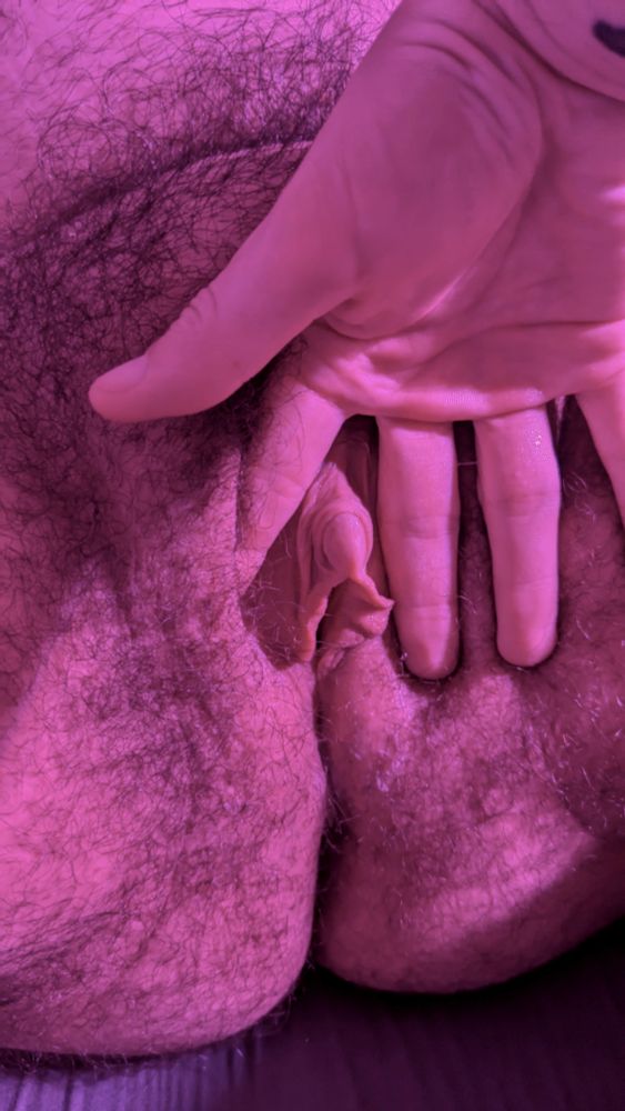 A hand spreading open my pussy to reveal my hard, thick tdick. It looks so tasty and suckable, like it belongs in your mouth.