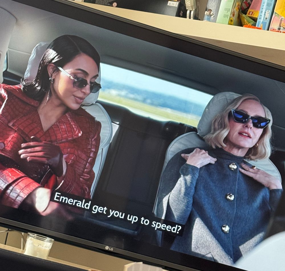 A photo of the show Alls Fair. Two well dressed women in a car. 