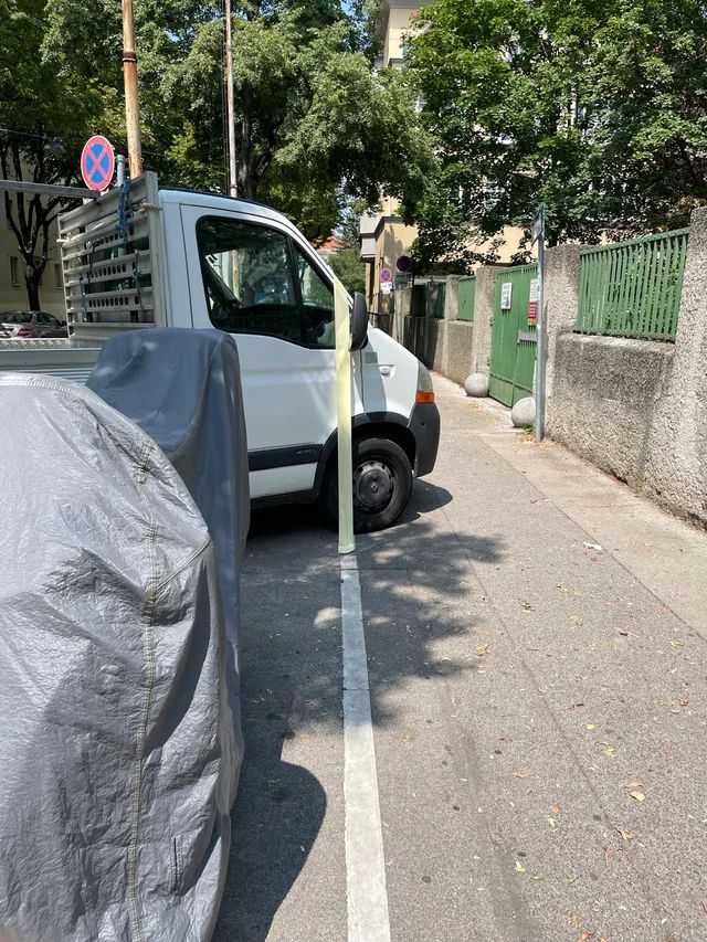 Van protruding onto the footway. Tape has been applied to the car to protest and highlight the obstruction. 