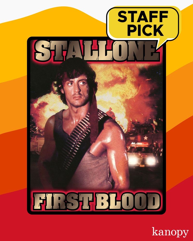 Sylvester Stallone shown in a tank top, sweating and looking off screen while wearing a bullet vest. A group of soldiers and police are shown in the background with a large, fiery explosion. Copy reads Stallone First Blood.