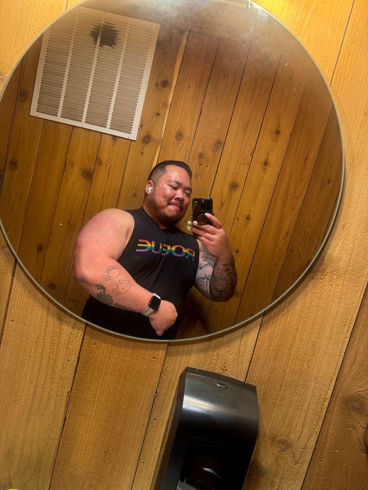 Danny flexing arm in mirror with arm down