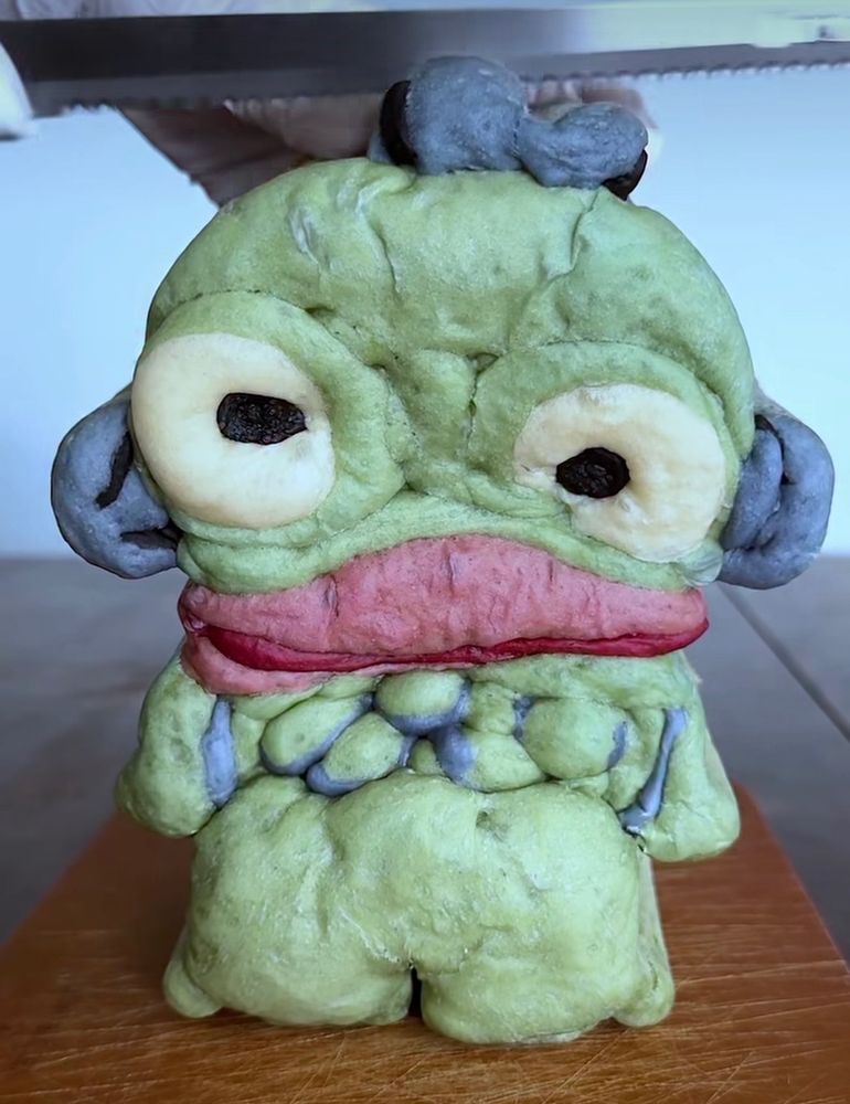 A silly loaf of hanyudon bread (character from Sanrio who is a fish monster that’s green and blue with big pink lips)