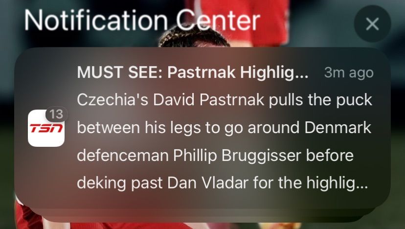 TSN notification on my phone titled "Must See: Pastrnak Highlight..." The actual text reads "Czechia's David Pastrnak pulls the puck between his legs to go around Denmark defenceman Phillip Bruggisser before deking past Dan Vladar for the highlight..." Dan Vladar is also playing for Czechia, so the notification is implying that Pastrnak scored an own goal.